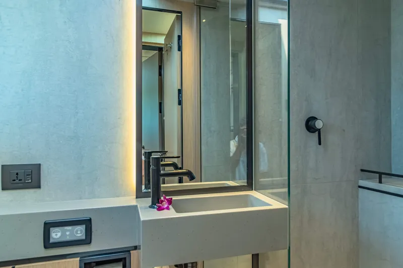 Jack Yacht Photos Pics Modern bathroom interior on McConaghy MC75 yacht, featuring sleek sink and mirror, 2023 model.