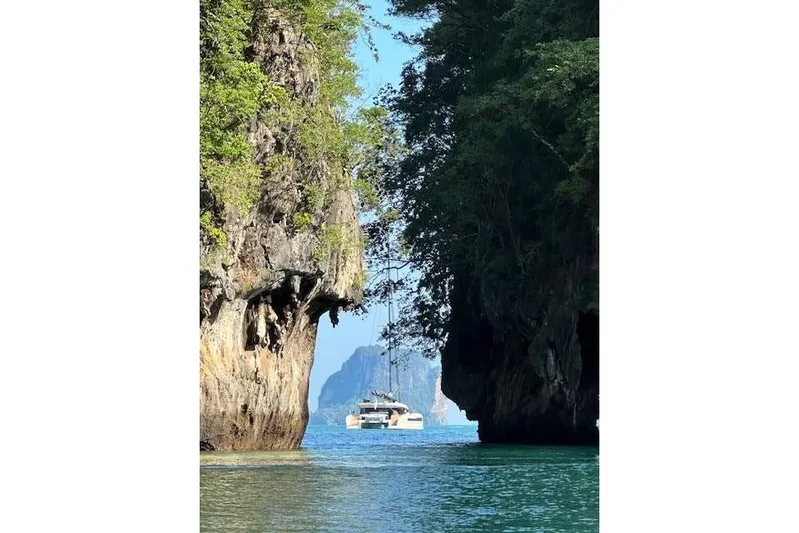 Jack Yacht Photos Pics 2023 McConaghy MC75 yacht sailing between lush cliffs in tropical waters.