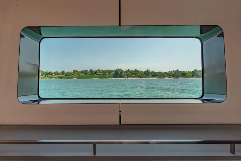 Jack Yacht Photos Pics View of serene waters and lush greenery through McConaghy MC75 yacht window, 2023 model.