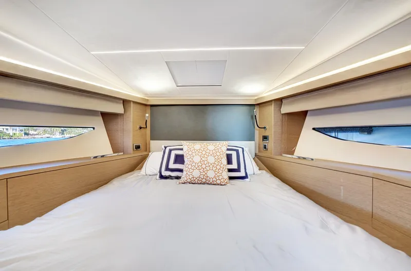 E Komo Mai Yacht Photos Pics Luxurious bedroom interior of 2022 Prestige 420S yacht with modern design and elegant bedding.