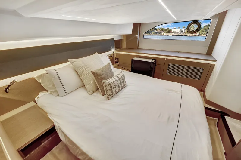 E Komo Mai Yacht Photos Pics Luxurious bedroom interior of 2022 Prestige 420S yacht with modern design and scenic window view.