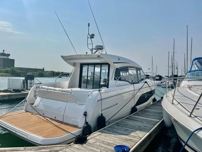 E Komo Mai Yacht Photos Pics Luxury 2022 Prestige 420S yacht docked at marina under clear sky.