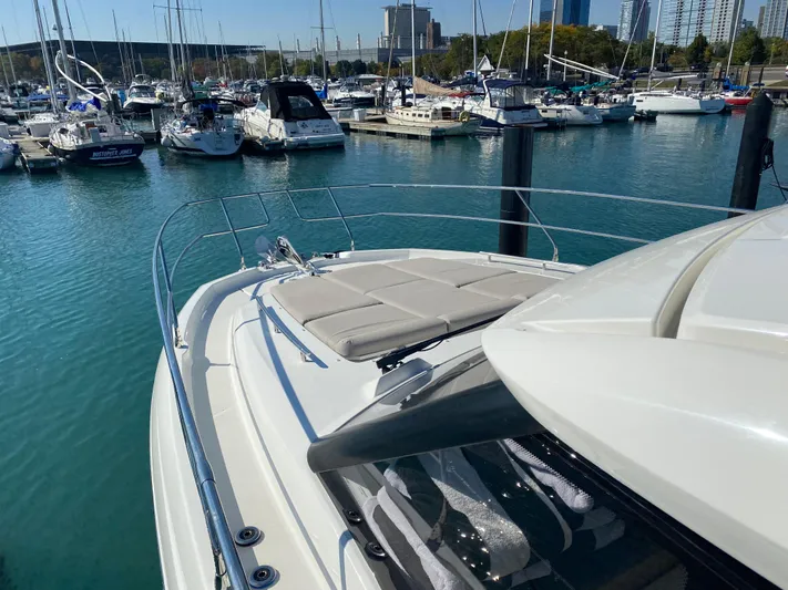 E Komo Mai Yacht Photos Pics Prestige 420S 2022 yacht docked in a marina with other boats.