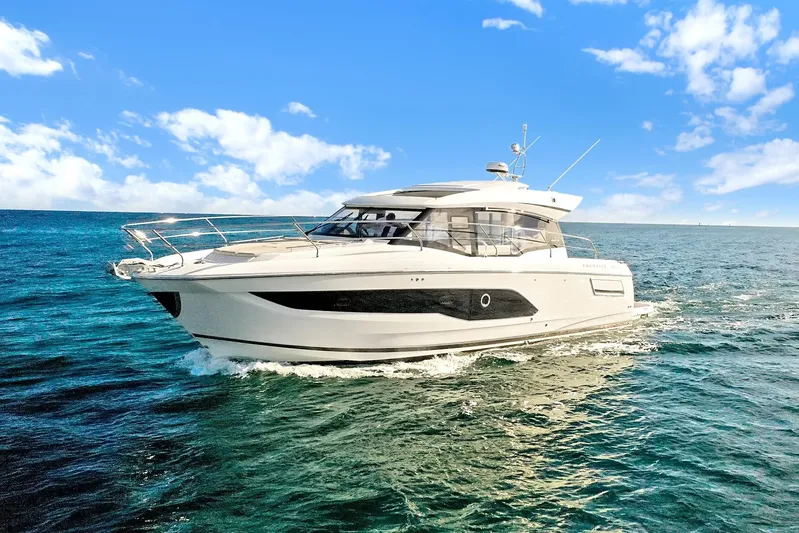 E Komo Mai Yacht Photos Pics 2022 Prestige 420S yacht cruising on open sea under clear blue sky.