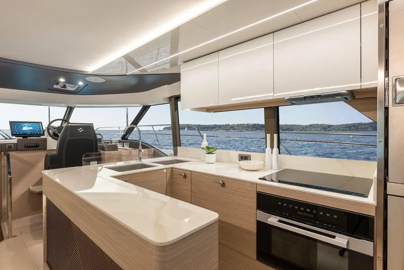  Yacht Photos Pics Luxurious interior of 2026 Prestige M48 yacht with modern kitchen and scenic ocean view.