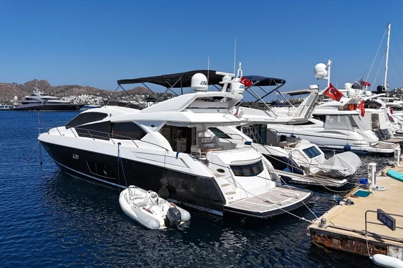  Yacht Photos Pics 2012 Sunseeker Manhattan 63 yacht docked in a marina, featuring sleek design and luxury amenities.