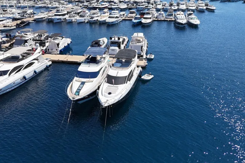  Yacht Photos Pics Luxury yachts, including a 2012 Sunseeker Manhattan 63, docked in a marina.