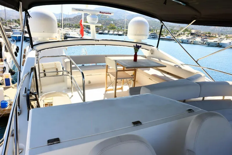  Yacht Photos Pics Luxurious 2012 Sunseeker Manhattan 63 yacht interior with elegant seating and table, docked at marina.