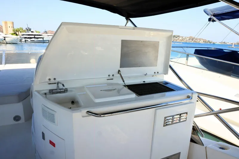  Yacht Photos Pics Outdoor kitchen on 2012 Sunseeker Manhattan 63 yacht with grill and sink, docked by the sea.