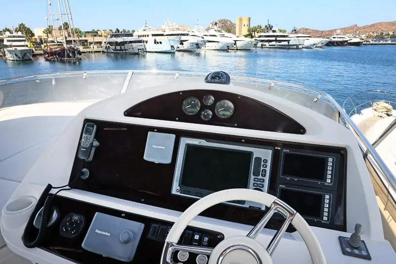  Yacht Photos Pics Cockpit view of 2012 Sunseeker Manhattan 63 yacht with marina in background.