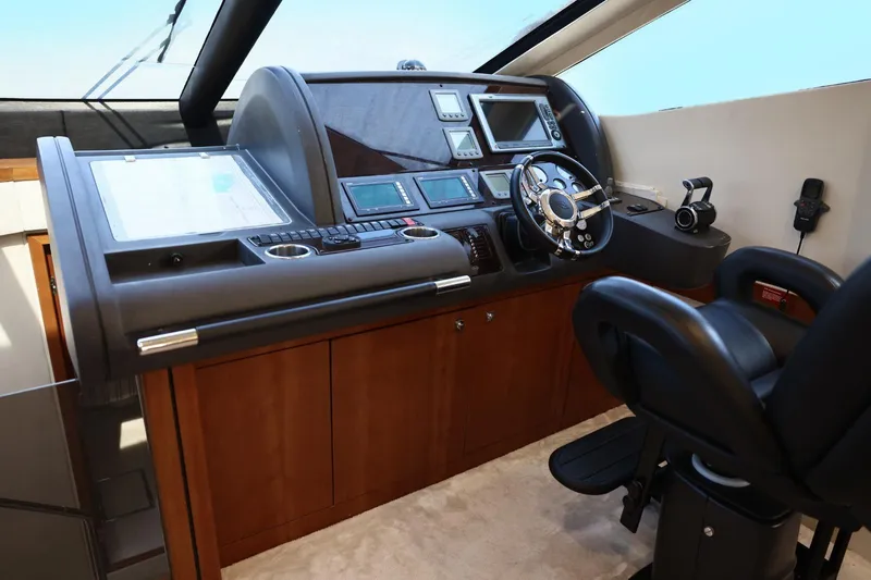  Yacht Photos Pics Helm station of 2012 Sunseeker Manhattan 63 yacht with modern navigation equipment.