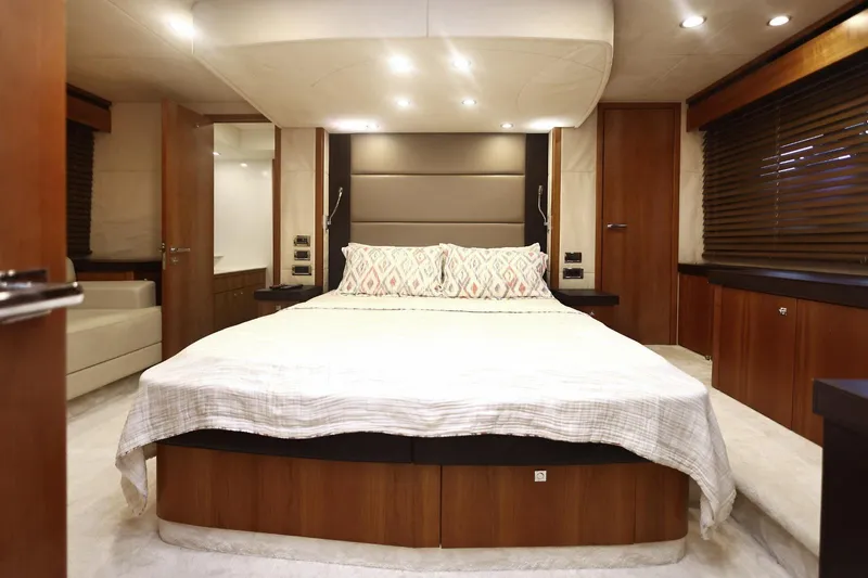  Yacht Photos Pics Luxurious bedroom interior of 2012 Sunseeker Manhattan 63 yacht, featuring elegant wood finishes.