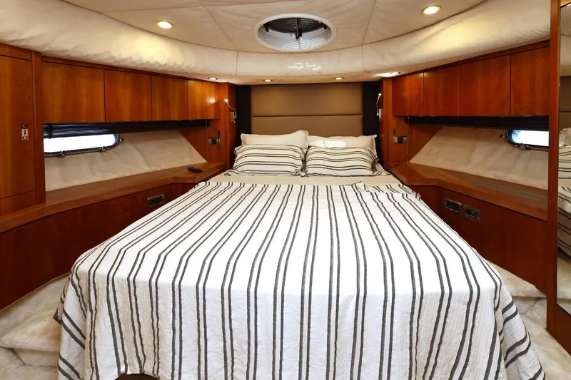  Yacht Photos Pics Luxurious cabin interior of 2012 Sunseeker Manhattan 63 yacht with striped bedding.