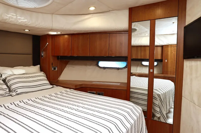  Yacht Photos Pics Luxurious cabin interior of 2012 Sunseeker Manhattan 63 yacht with striped bedding.