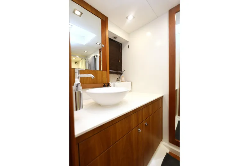  Yacht Photos Pics Luxurious bathroom interior on 2012 Sunseeker Manhattan 63 yacht, featuring modern sink and wood cabinetry.