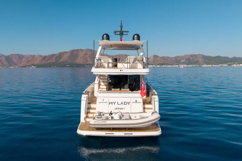 My Lady Yacht Photos Pics Princess 72 Flybridge Motor Yacht 2014 on calm sea with mountainous backdrop.