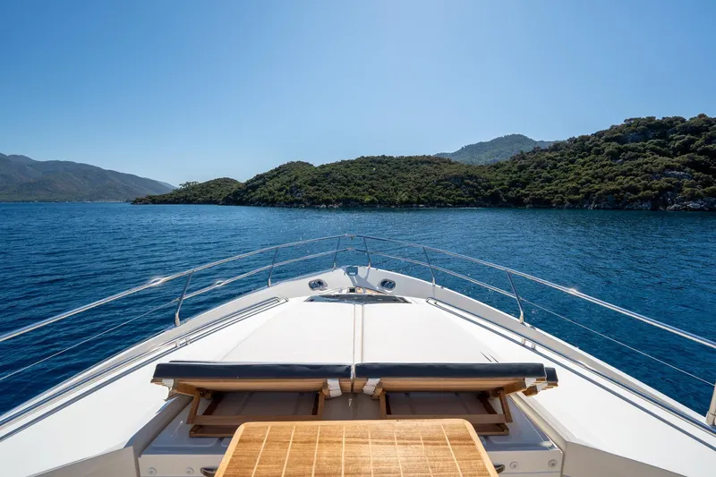 My Lady Yacht Photos Pics Bow view of 2014 Princess 72 Flybridge Motor Yacht cruising near lush islands.