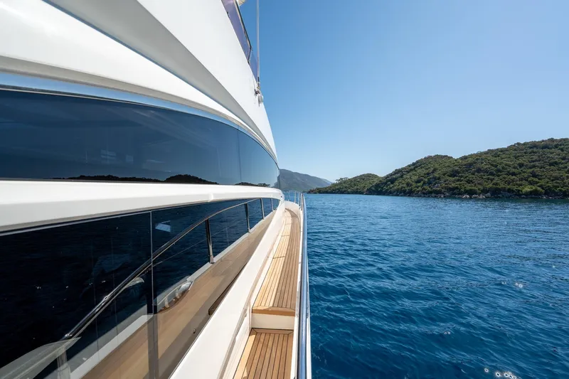 My Lady Yacht Photos Pics Side view of 2014 Princess 72 Flybridge Motor Yacht cruising near scenic coastline.