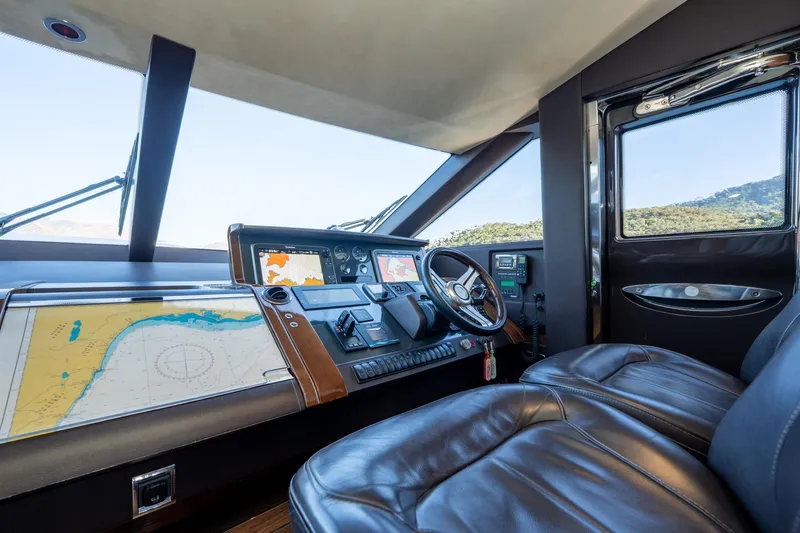 My Lady Yacht Photos Pics Helm of 2014 Princess 72 Flybridge Motor Yacht with navigation equipment and leather seating.