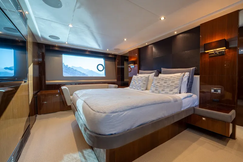 My Lady Yacht Photos Pics Luxurious bedroom interior of 2014 Princess 72 Flybridge Motor Yacht with elegant wood finishes.