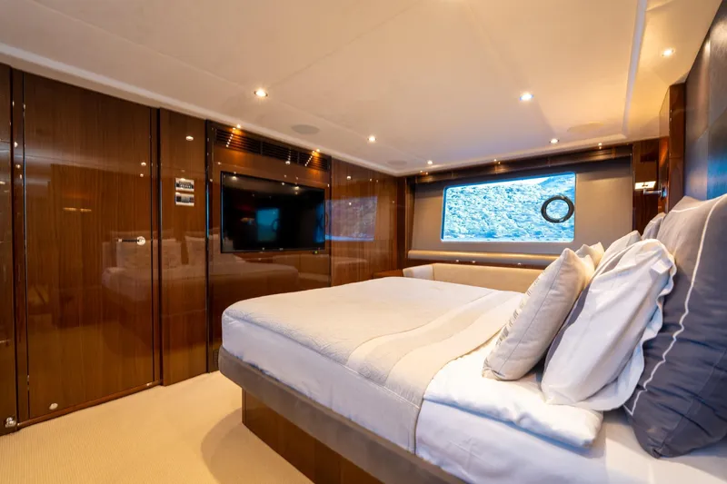My Lady Yacht Photos Pics Luxurious bedroom interior of 2014 Princess 72 Flybridge Motor Yacht with elegant wood finishes.