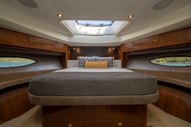 My Lady Yacht Photos Pics Luxurious bedroom interior of 2014 Princess 72 Flybridge Motor Yacht with elegant wood finishes.