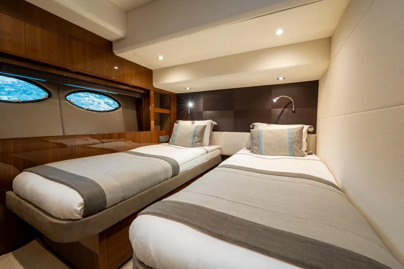 My Lady Yacht Photos Pics Luxurious twin cabin in 2014 Princess 72 Flybridge Motor Yacht, featuring elegant bedding and porthole windows.