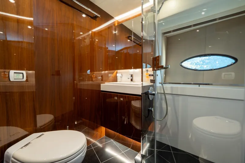 My Lady Yacht Photos Pics Luxurious bathroom in 2014 Princess 72 Flybridge Motor Yacht with sleek wood finishes.