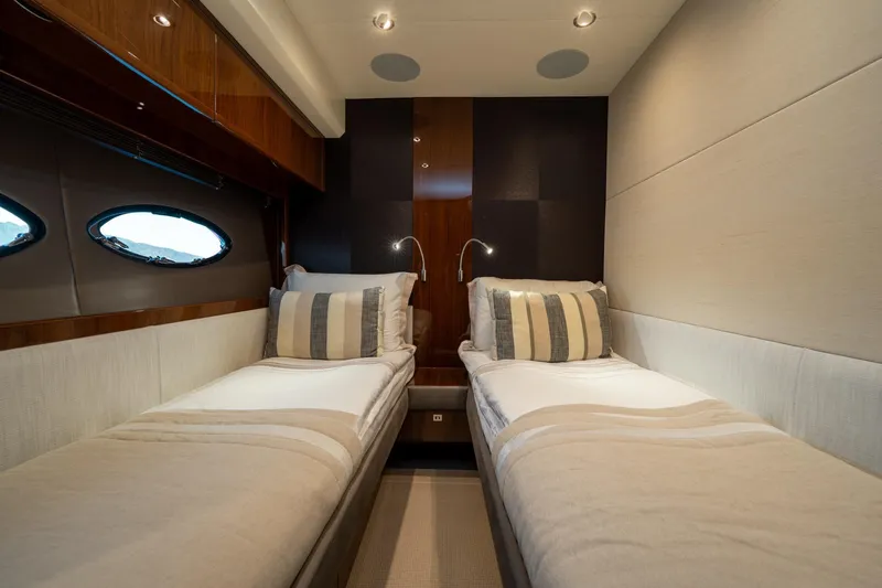 My Lady Yacht Photos Pics Luxurious twin cabin in 2014 Princess 72 Flybridge Motor Yacht, featuring elegant decor and porthole windows.