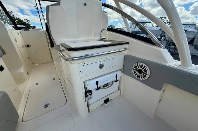  Yacht Photos Pics 2026 Scout 255 Dorado boat interior with sink, storage, and Yeti cooler.