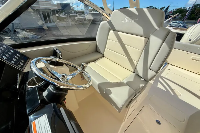  Yacht Photos Pics 2026 Scout 255 Dorado boat interior with steering wheel and beige seating.