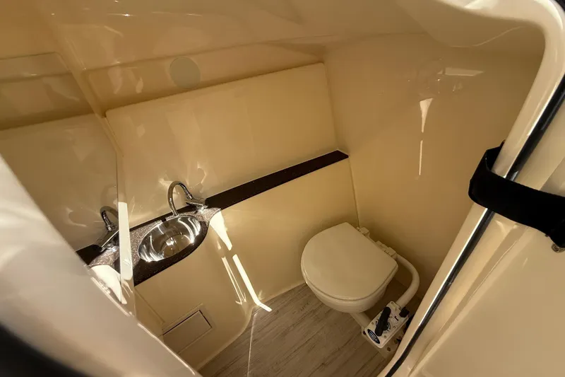  Yacht Photos Pics 2026 Scout 255 Dorado boat interior with sink and toilet in compact bathroom.