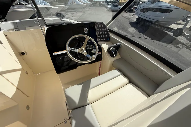  Yacht Photos Pics 2026 Scout 255 Dorado boat interior with steering wheel and control panel.
