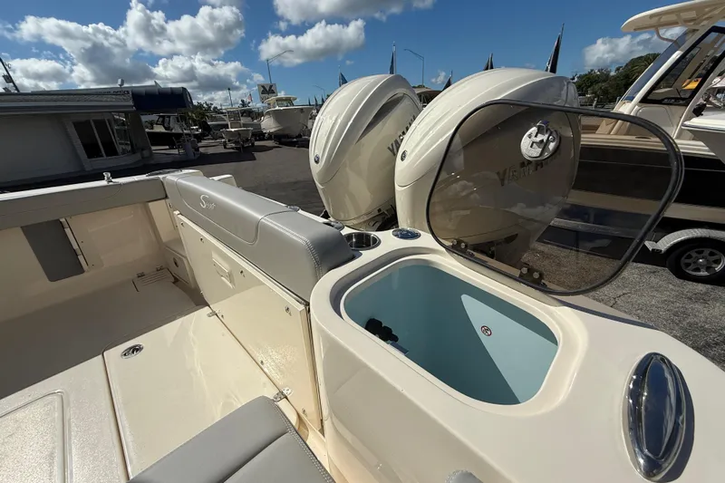  Yacht Photos Pics 2026 Scout 255 Dorado boat with dual Yamaha engines and open storage compartment.