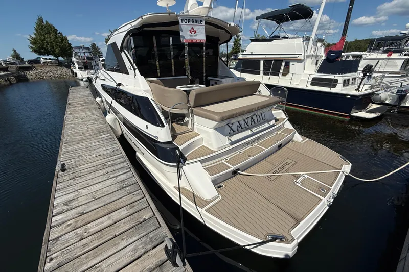  Yacht Photos Pics 2015 Regal 46 Sport Coupe yacht docked, labeled "Xanadu," with a "For Sale" sign.