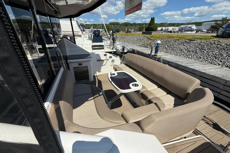  Yacht Photos Pics 2015 Regal 46 Sport Coupe yacht with outdoor seating and table on deck.