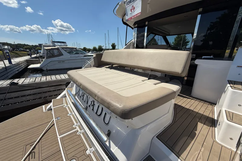  Yacht Photos Pics 2015 Regal 46 Sport Coupe yacht with beige seating at a marina dock.