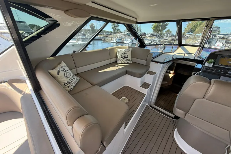  Yacht Photos Pics Luxurious interior of 2015 Regal 46 Sport Coupe yacht with plush seating and scenic marina view.