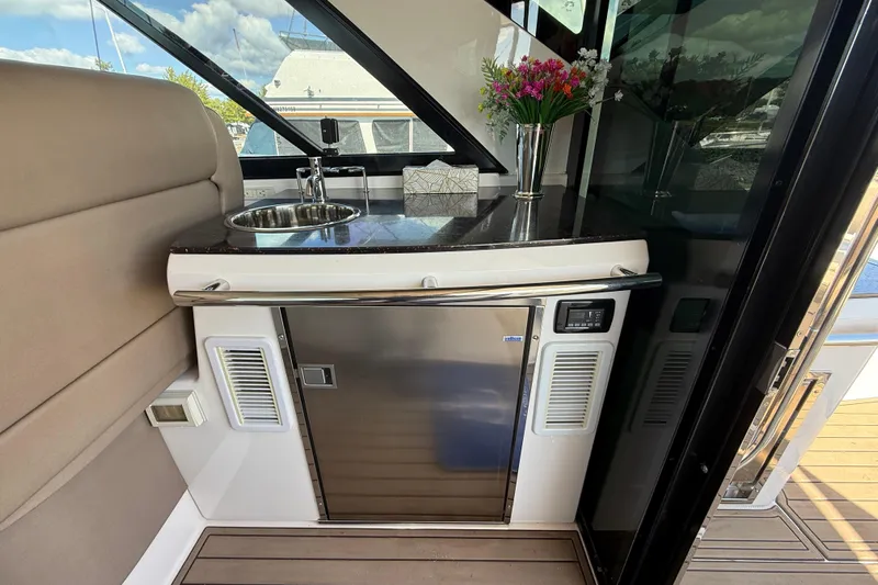  Yacht Photos Pics Interior of 2015 Regal 46 Sport Coupe yacht with kitchenette and floral decor.