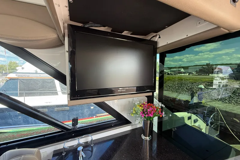  Yacht Photos Pics Interior of 2015 Regal 46 Sport Coupe with TV and floral arrangement.