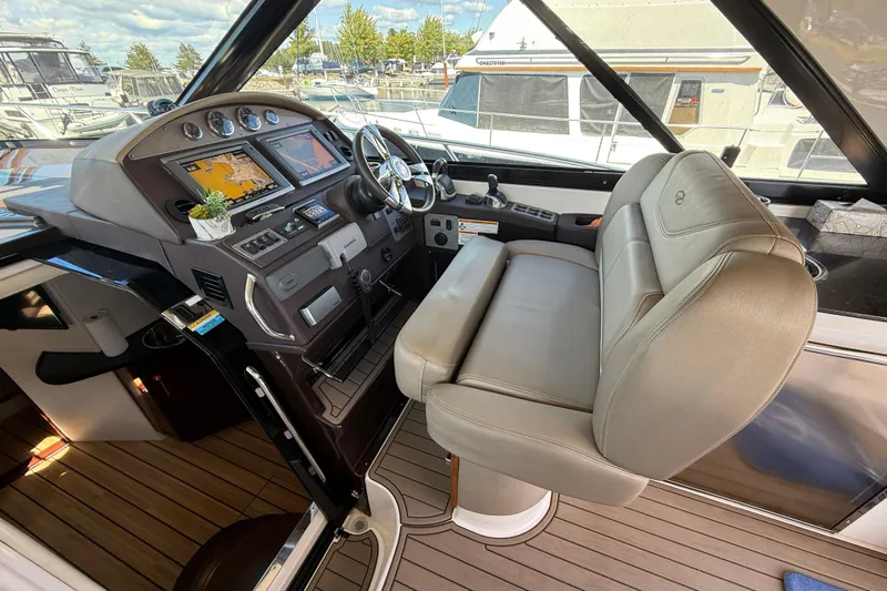  Yacht Photos Pics 2015 Regal 46 Sport Coupe helm with navigation screens and leather captain's chair.