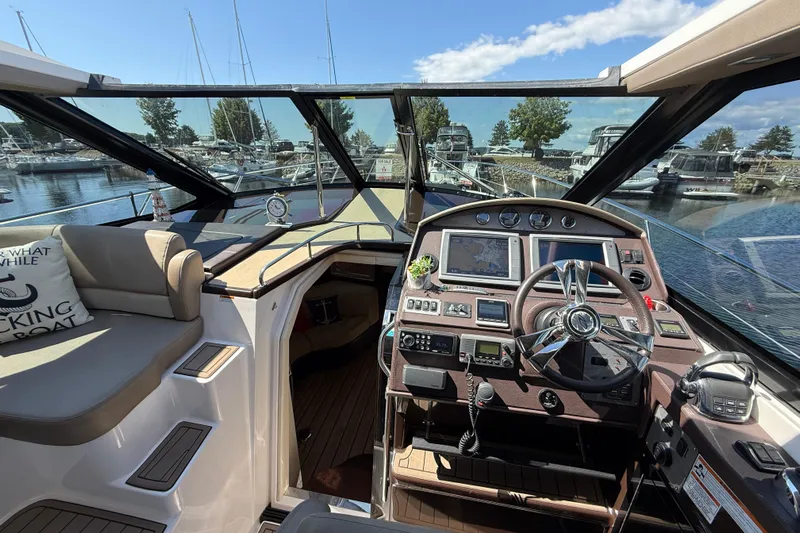  Yacht Photos Pics 2015 Regal 46 Sport Coupe yacht interior with helm, navigation screens, and seating area.