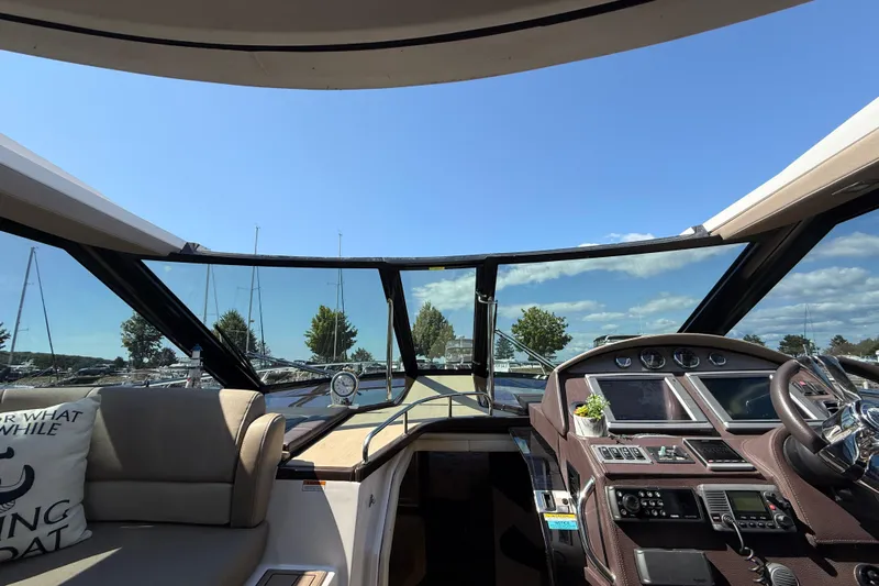  Yacht Photos Pics Interior view of 2015 Regal 46 Sport Coupe yacht cockpit with steering wheel and dashboard.