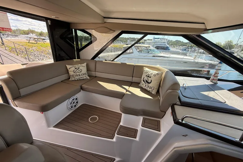  Yacht Photos Pics Luxurious interior of 2015 Regal 46 Sport Coupe yacht with plush seating and scenic marina view.