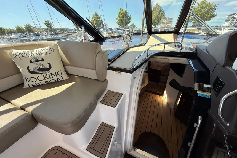  Yacht Photos Pics 2015 Regal 46 Sport Coupe interior with seating, nautical pillow, and cabin entrance.