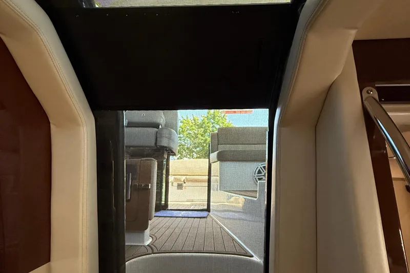  Yacht Photos Pics Interior view of 2015 Regal 46 Sport Coupe yacht, showcasing seating and deck area.