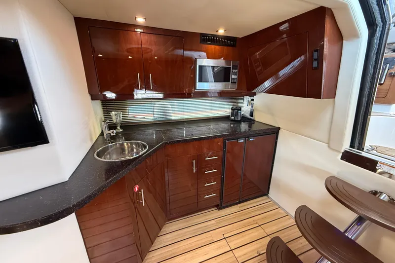  Yacht Photos Pics Luxurious kitchen interior of 2015 Regal 46 Sport Coupe yacht with modern amenities.