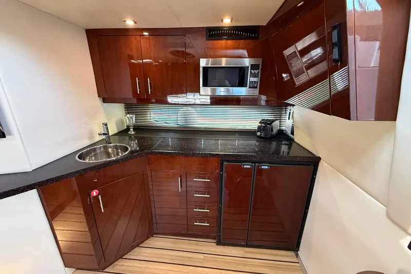  Yacht Photos Pics Luxurious 2015 Regal 46 Sport Coupe yacht kitchen with sleek cabinetry and modern appliances.