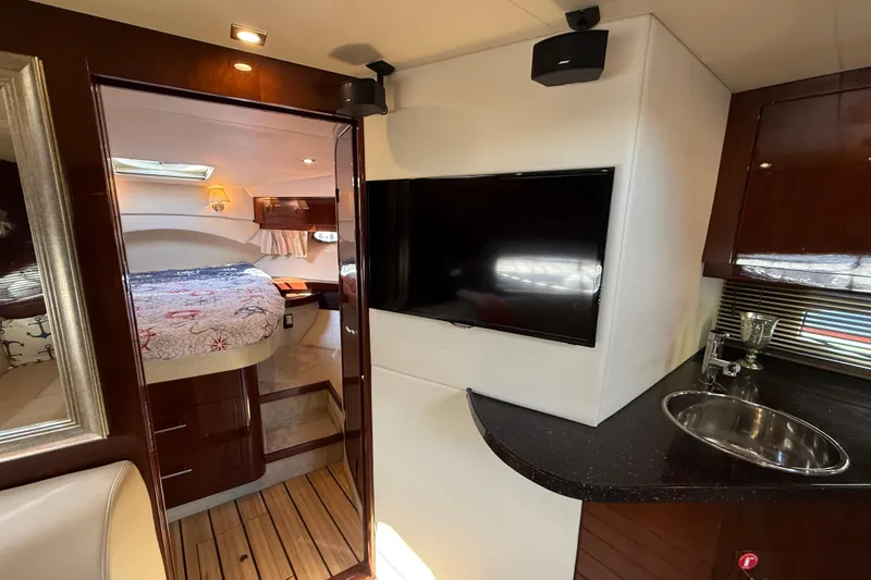  Yacht Photos Pics 2015 Regal 46 Sport Coupe interior with bedroom, TV, and kitchenette.