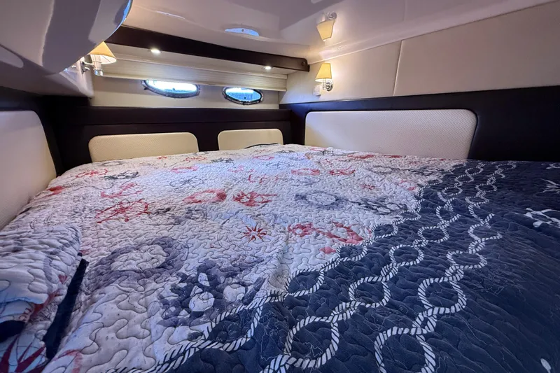  Yacht Photos Pics Luxurious cabin interior of 2015 Regal 46 Sport Coupe with nautical-themed bedding.